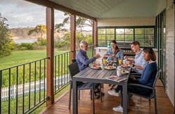 People dining on the verandah at Middle Head Officers Quarters, Sydney Harbour National Park. Photo credit: John Spencer © DPIE