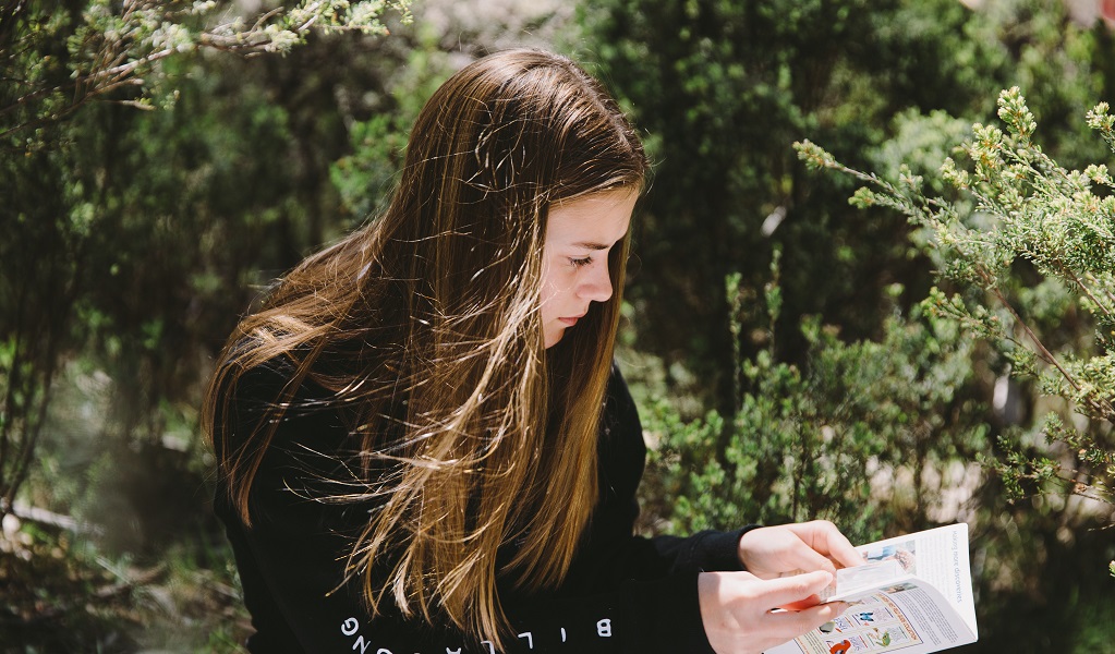 Female secondary student checking information in a handbook, Kosciuszko National Park. Credit: Remy Brand &copy; Remy Brand/DCCEEW