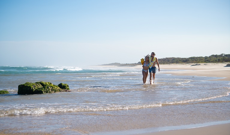 A couple enjoying the beach near Kylies Beach campground, Crowdy Bay National Park. Photo: Rob Mulally/DPIE