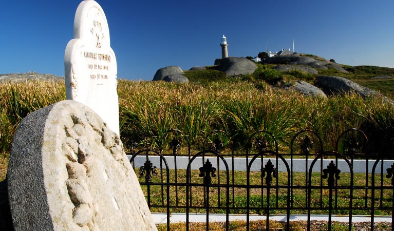 Gravestones at cemetery below the lighthouse, on Barunguba Montague Island Nature Reserve. Learn about Montague Island Nature Reserve's Aboriginal heritage, it's colonial history, and the island's remarkable plants and animals on a walking tour. Photo: Stuart Cohen/OEH