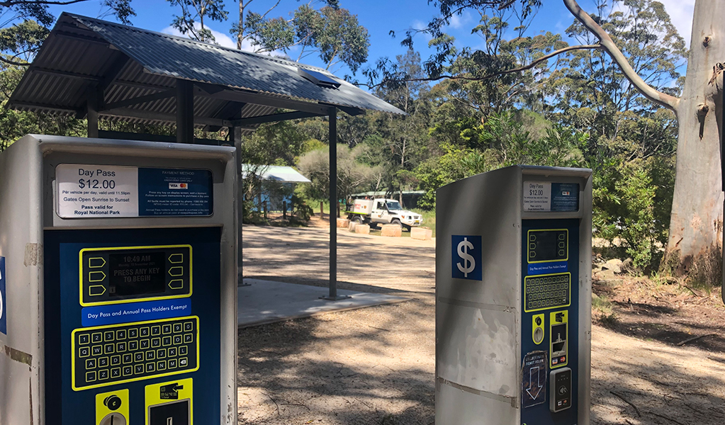 Parking meters and signage at Garawarra Farm carpark. Photo: Natasha Webb