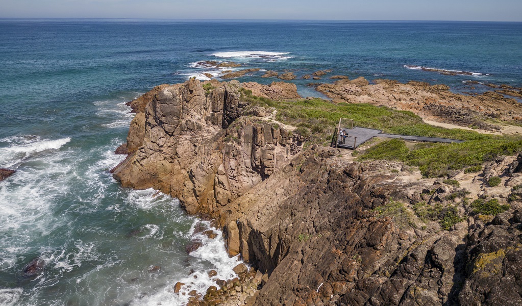 A lookout perched on the rugged cliff edge along Tomaree Coastal walk, near Iris Moore lookout and picnic area in Tomaree National Park. Photo: John Spencer © DPE